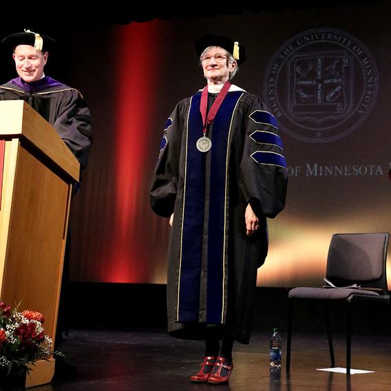 University of Minnesota Interim President Jeff Ettinger and Chancellor Janet Ericksen on stage in academic regalia